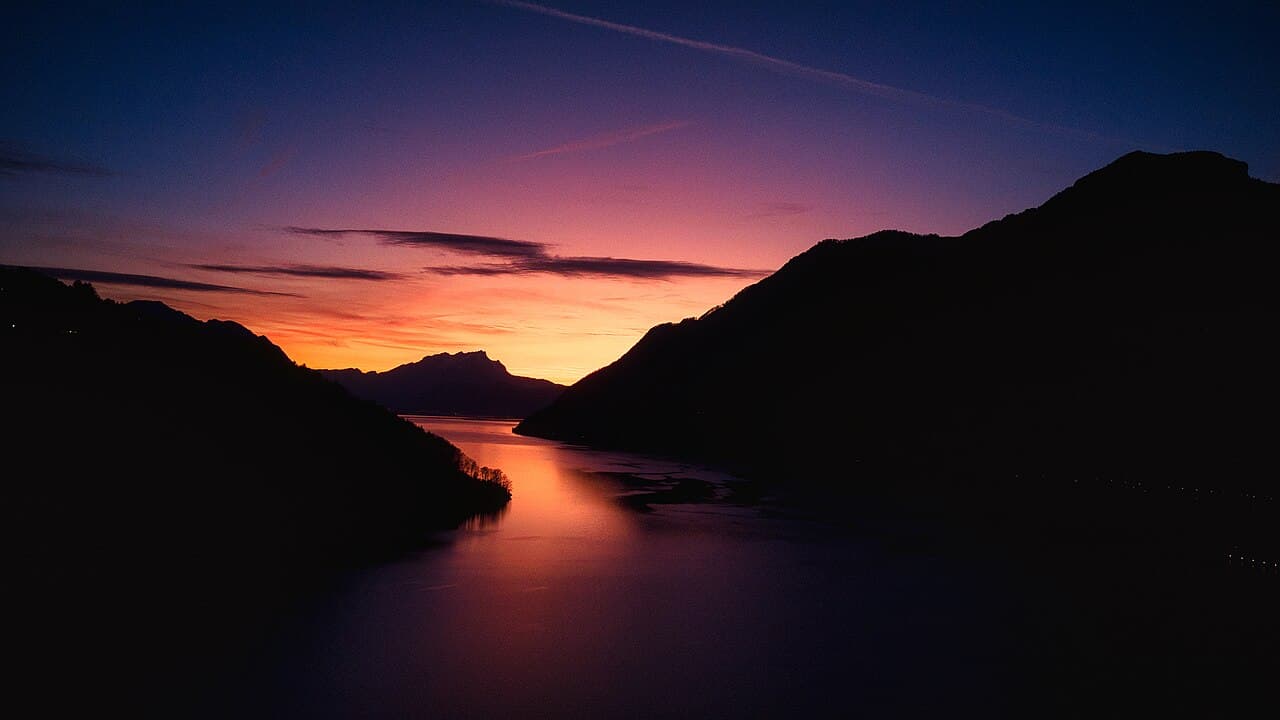 Lac des Quatre-Cantons au coucher du soleil depuis Brunnen, entre les silhouettes des montagnes